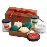 box with holiday gifts, two candles, soap set, body butter in a Christmas theme