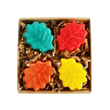A box of four leaf soaps, one yellow, one green, one red, and one orange.